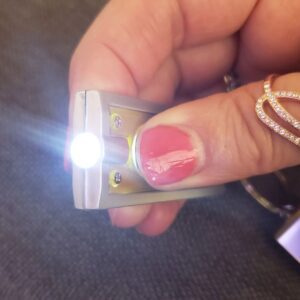 LED keychain flashlight in use