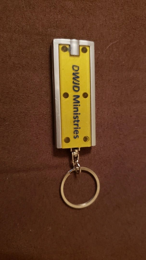 Keychain flashlight labeled DWJD Ministries