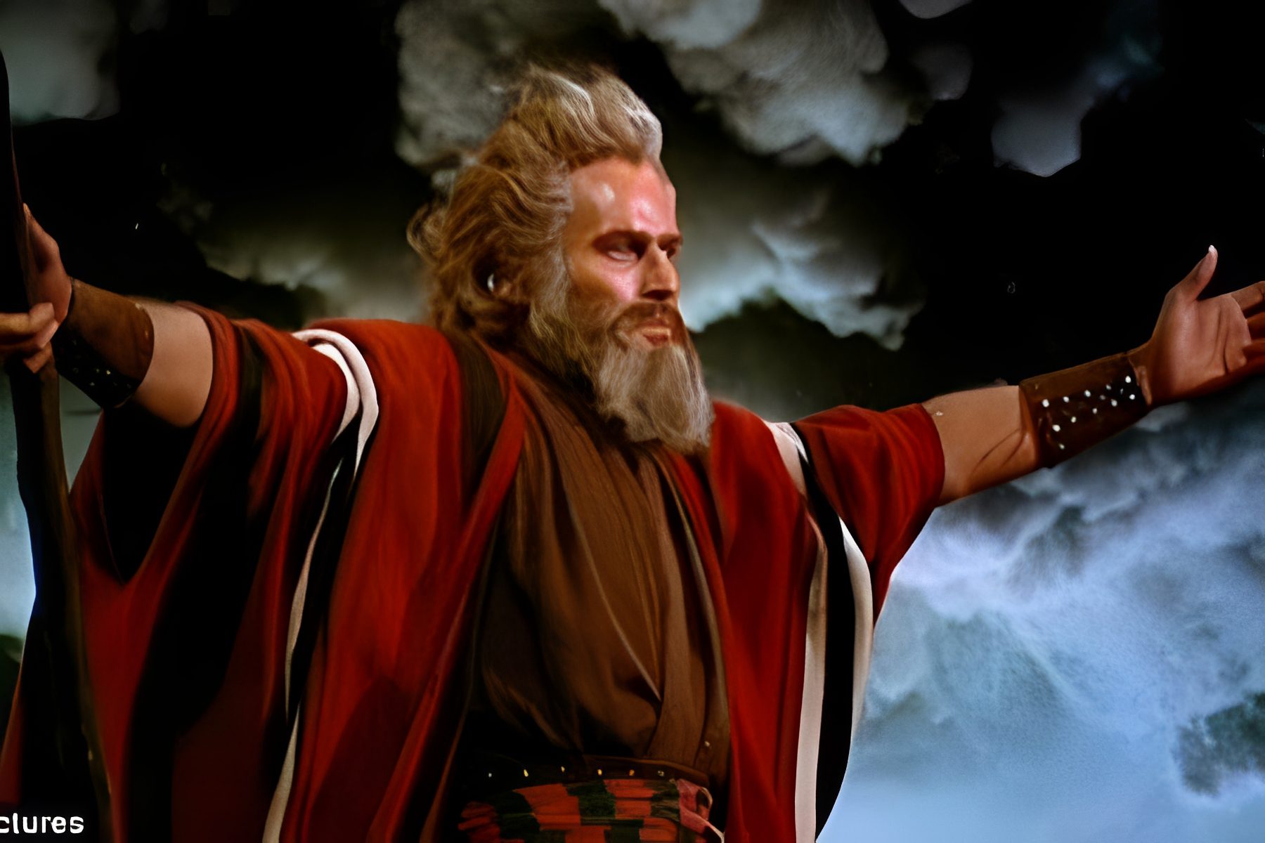 Man in red robe with outstretched arms