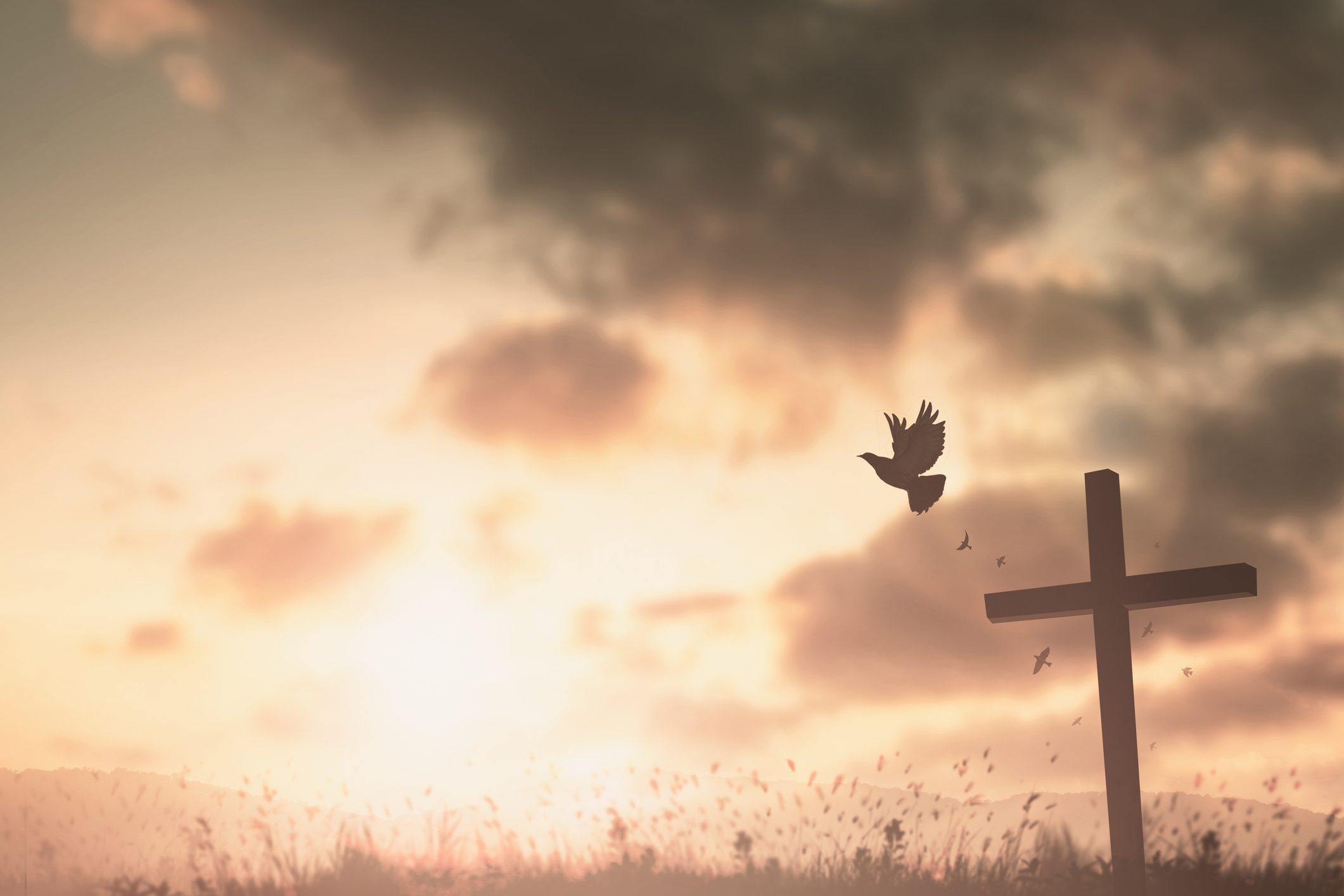 Silhouette of cross at sunset