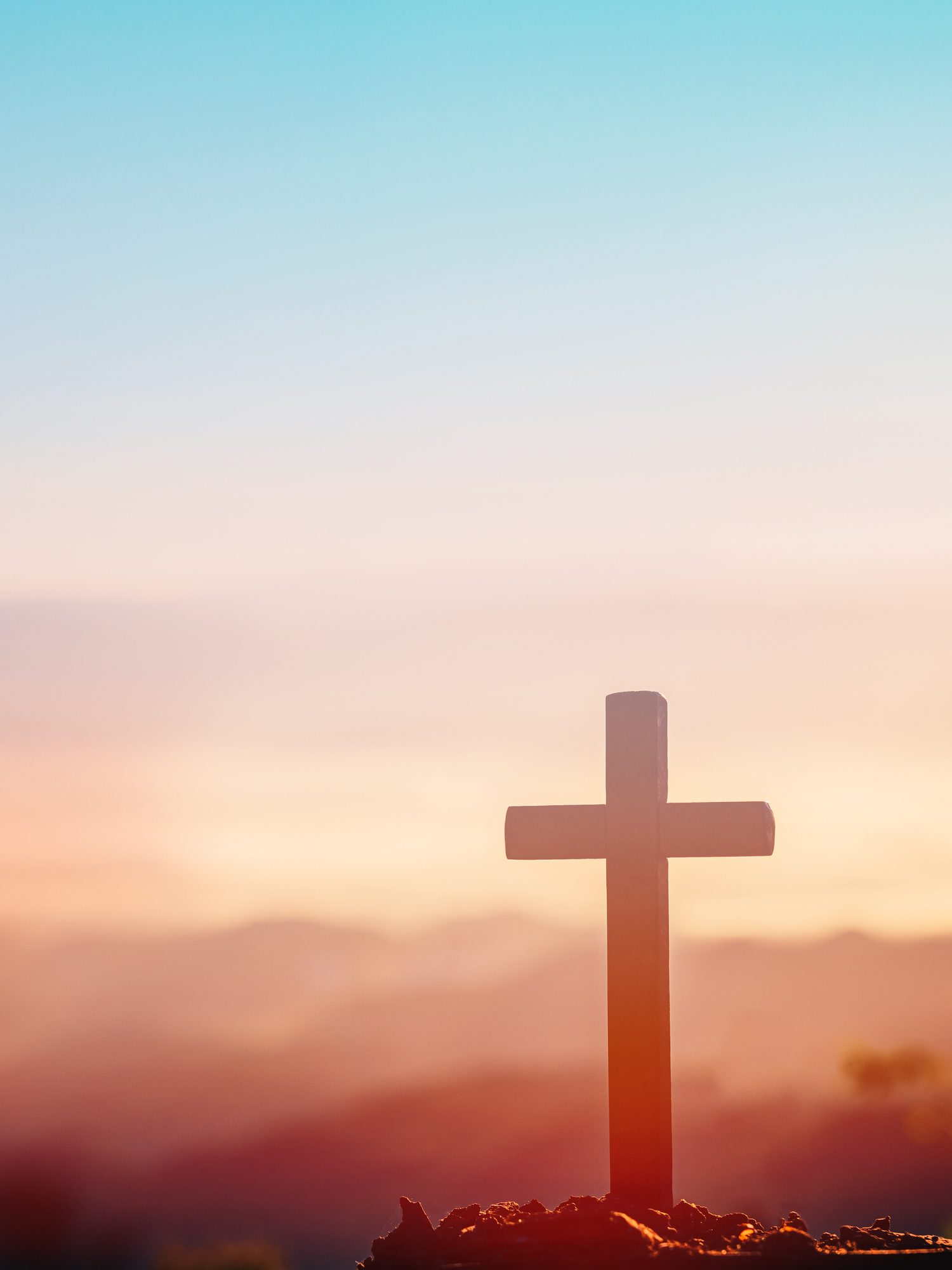Sunrise behind a solitary cross