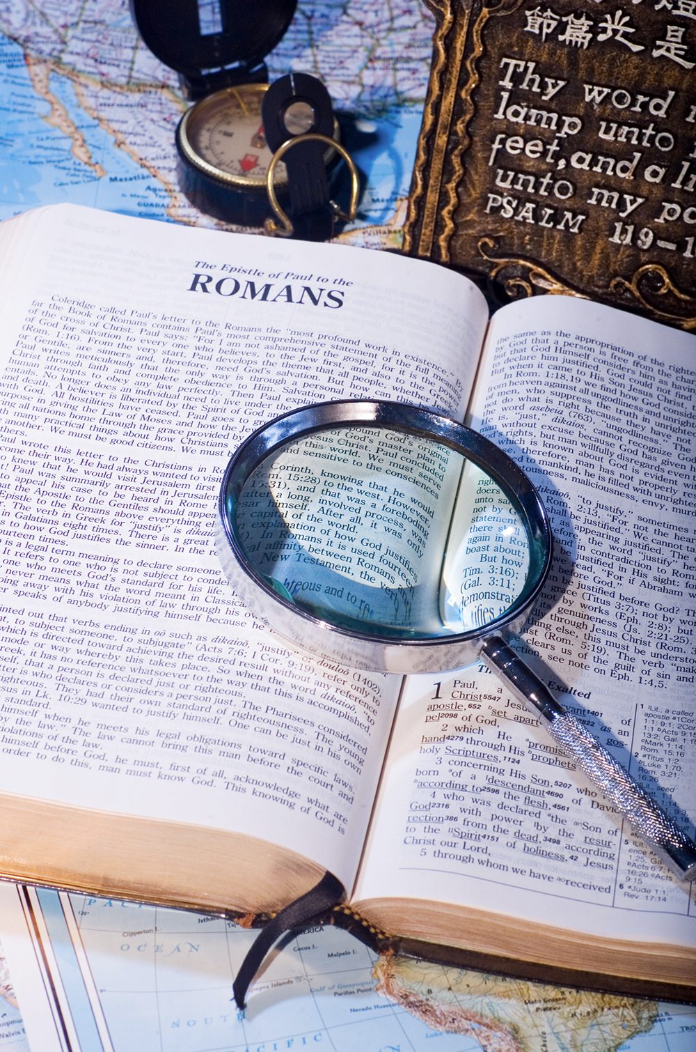 Open Bible with magnifying glass