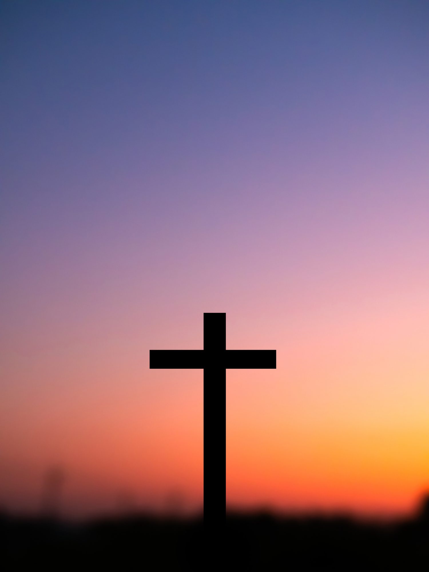 Sunset behind a silhouetted cross