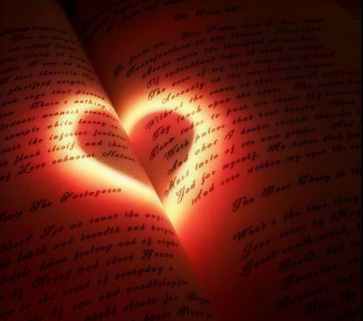 Light casting heart on written pages