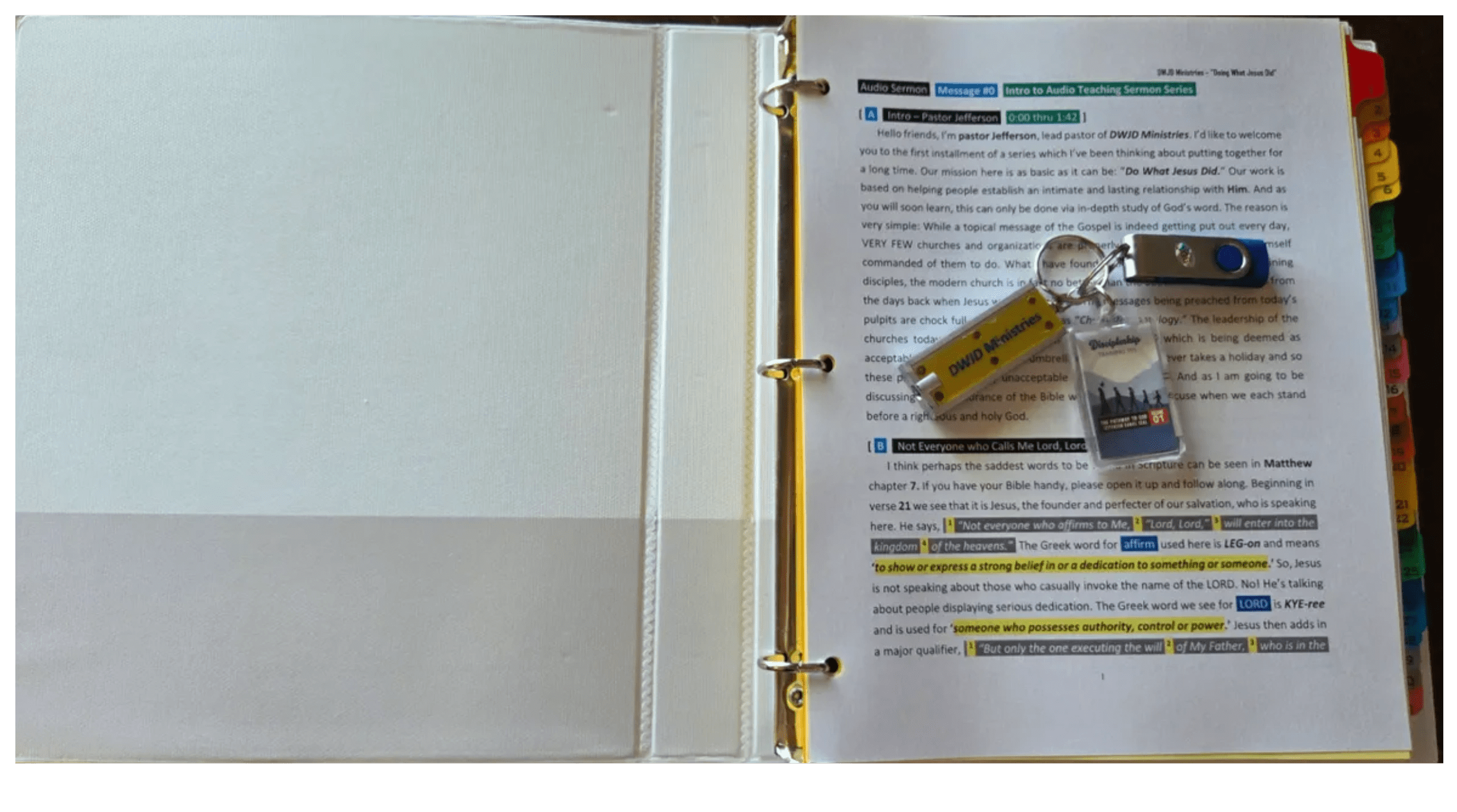 Open binder showing organized documents and USBs.
